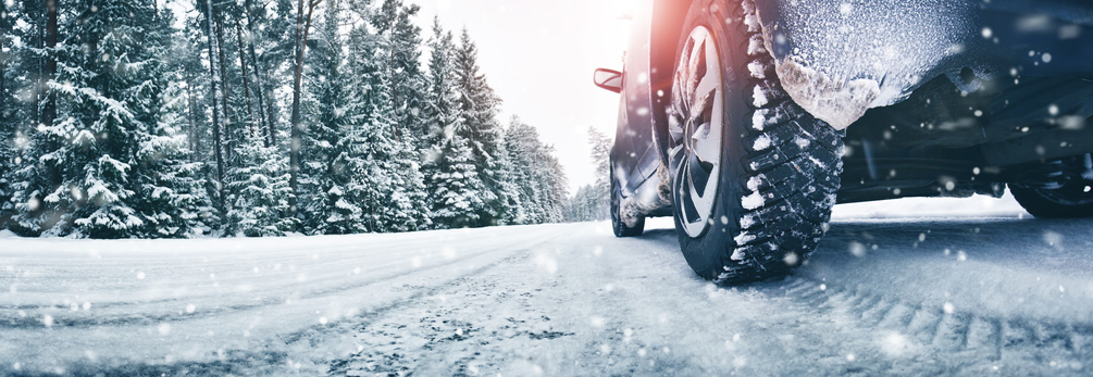 Closeup of car tires in winter on the road