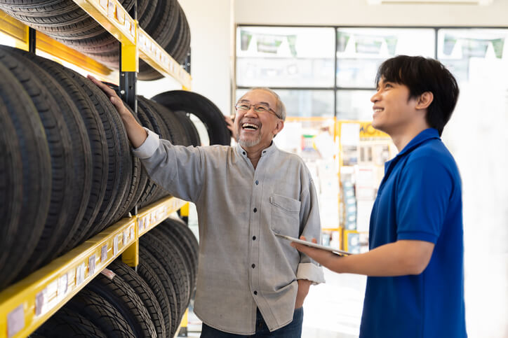 service advisor training graduate helping customer select a tire