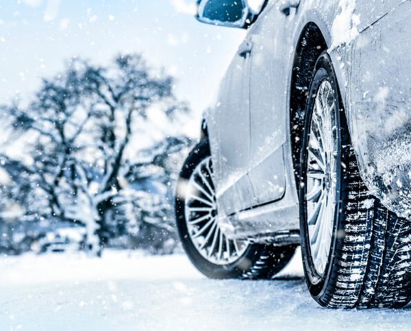 An auto mechanic school student testing tires in a snow environment.
