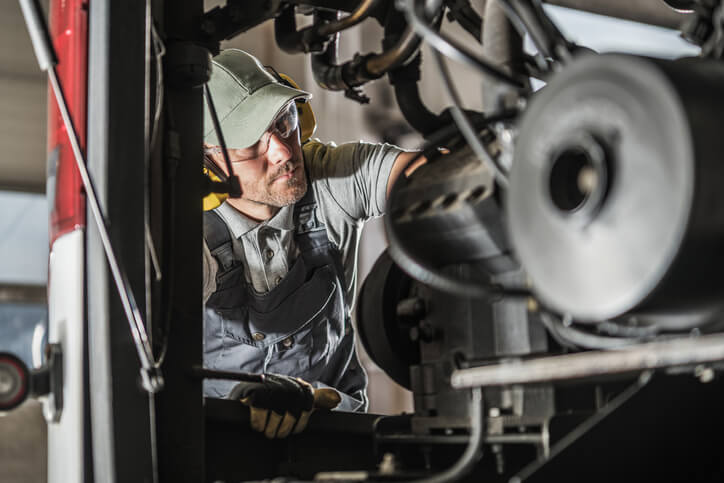 A mechanic working on a diesel engine after diesel mechanic training