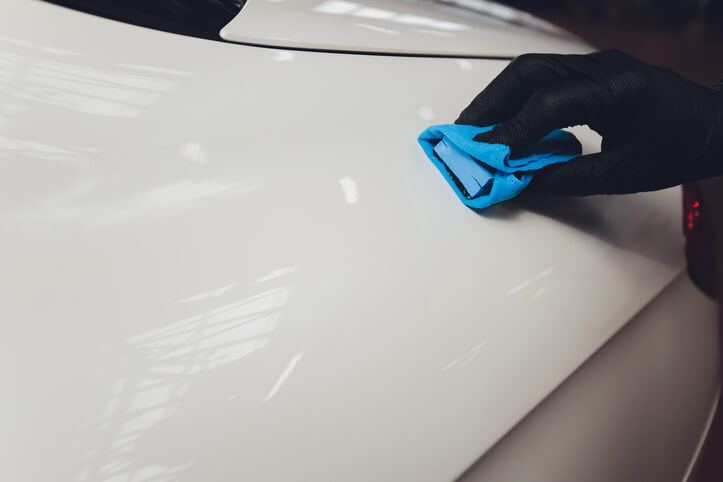 An auto detailing professional washing a car after auto body training