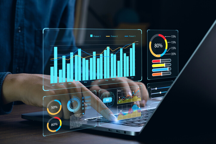 An auto sales training grad analyzing data on a computer