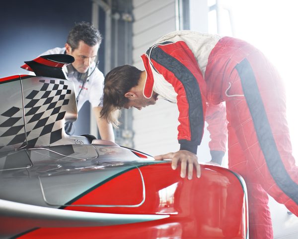 Race car mechanics working on a car after diesel mechanic training
