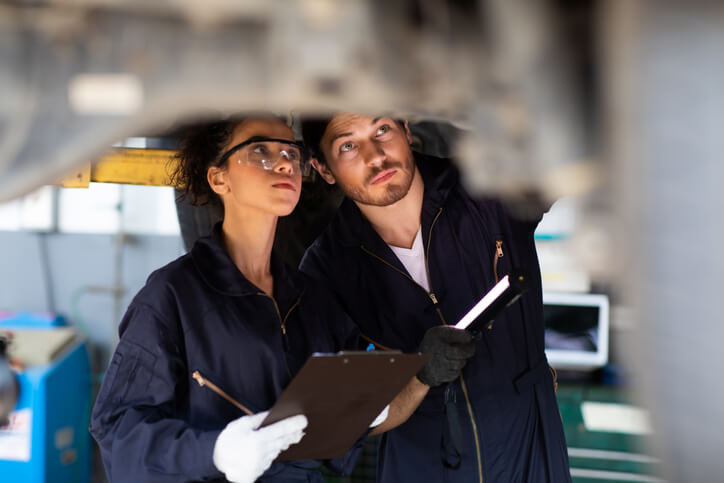 A student at CATI using a hydraulic lift during automotive training