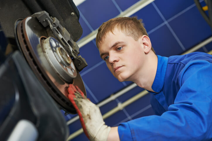 A CATI school student working on a vehicle’s braking system