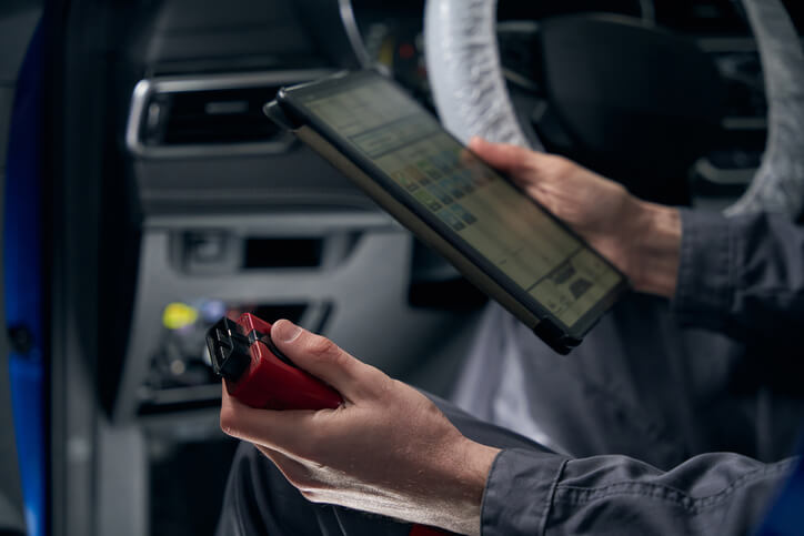 A technician updating a vehicle’s control module
