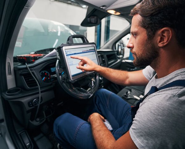 An automotive student performing module reprogramming