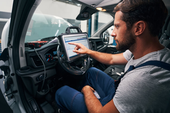 An automotive student performing module reprogramming