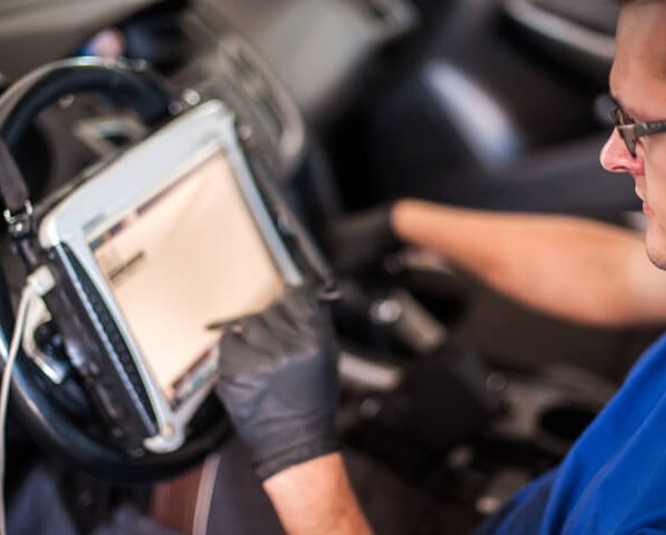 A student using diagnostic tools in automotive training
