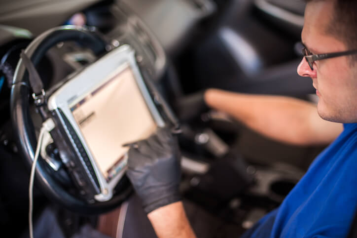 A student using diagnostic tools in automotive training
