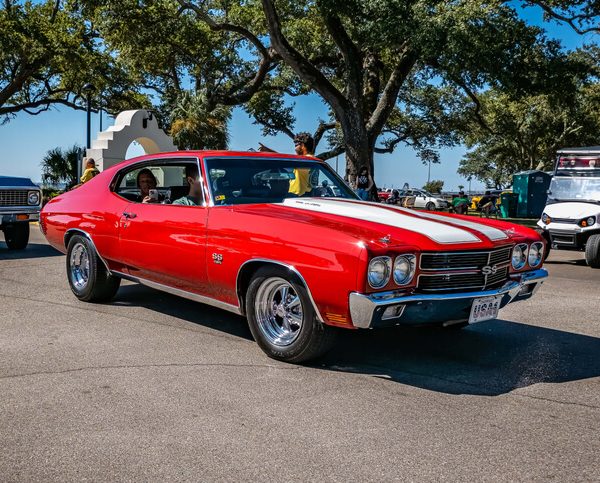 Restored red Chevrolet Chevelle SS muscle car, highlighting opportunities in auto mechanic training to combine classic restoration with electric vehicle technology.