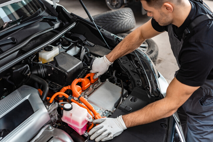 An automotive training graduate on a hydrogen fuel cell vehicle in a CATI shop