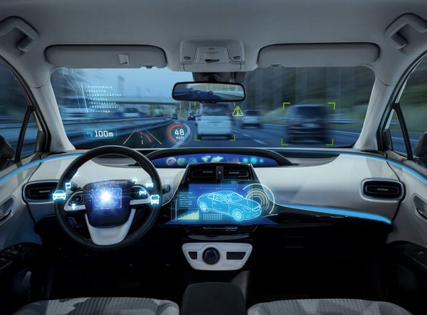 A self-driving car equipped with sensors, cameras, and radar systems used in modern auto mechanic training.