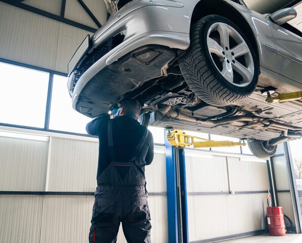 A student practicing with a torque wrench during auto mechanic training