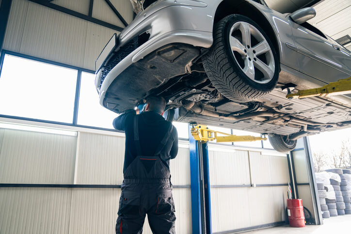 A student practicing with a torque wrench during auto mechanic training