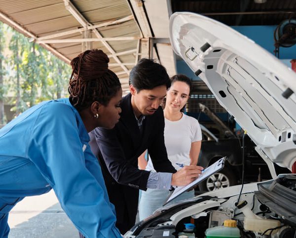 A pair of apprentice mechanics learning engine inspection during auto mechanic training at CATI.