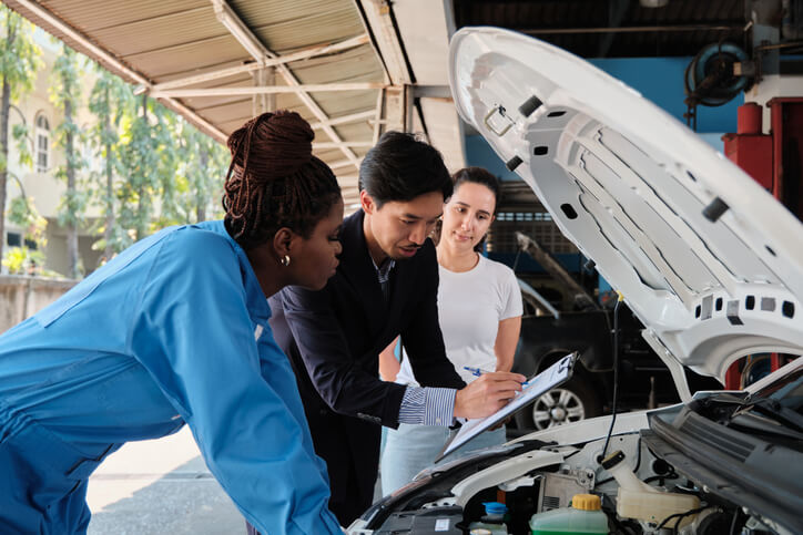 A pair of apprentice mechanics learning engine inspection during auto mechanic training at CATI.