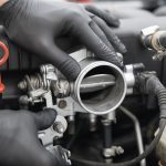 Technician inspecting a throttle body