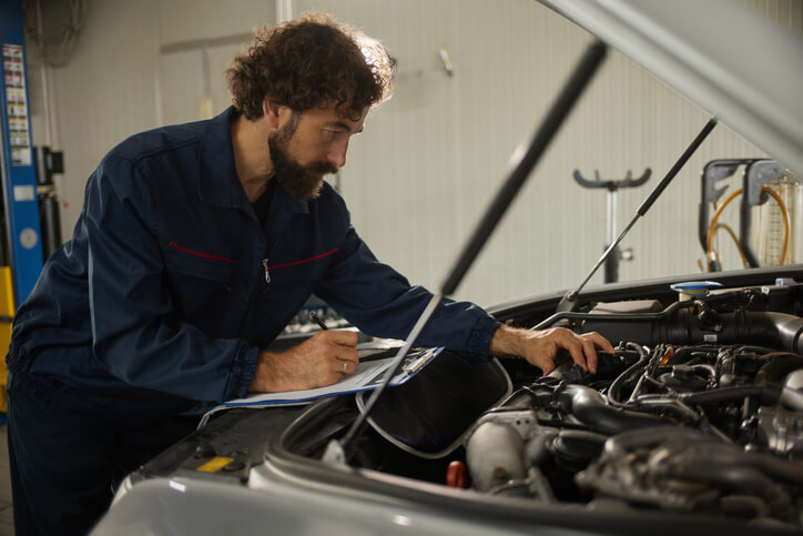 An automotive technician performing maintenance in a Canadian repair facility, demonstrating the Canadian automotive aftermarket outlook