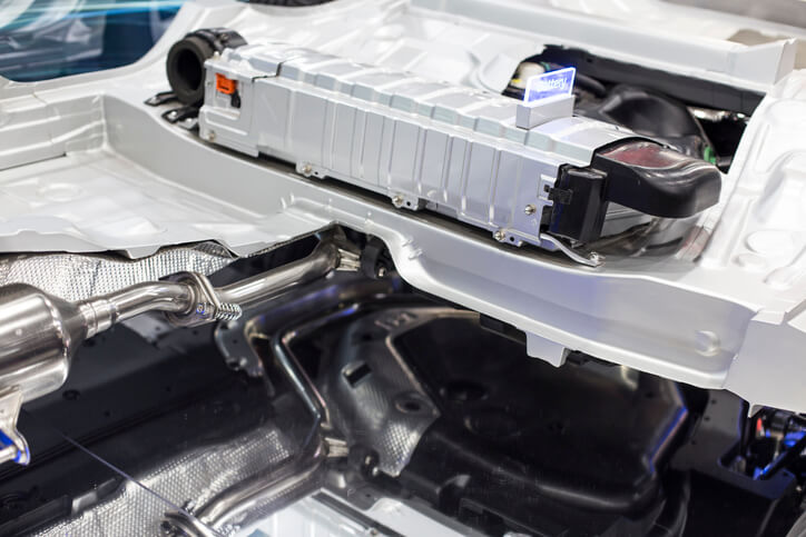 A high-voltage hybrid battery pack is being inspected during replacement