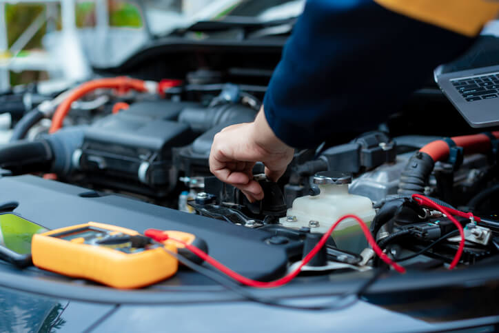 A technician inspects engine components after the leak-down test results identify faults