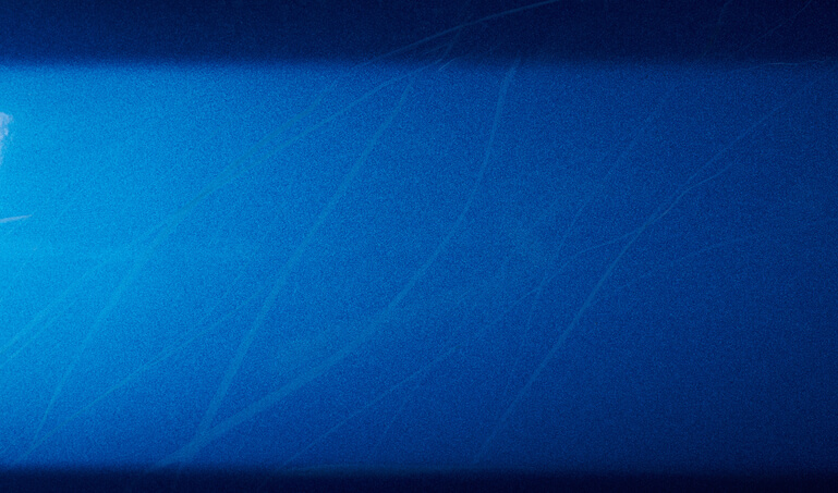 A close-up of swirl marks on the car paint before paint correction