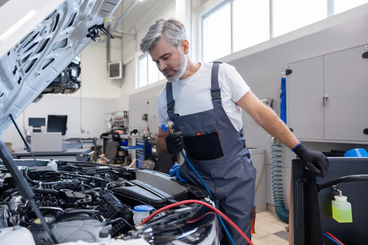 A technician inspecting an EV cooling system