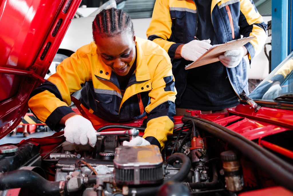 An automotive student learning fleet maintenance procedures during hands-on training