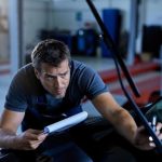 Technician diagnosing a windshield washer not working on a vehicle