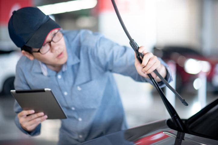 Automotive student testing a windshield washer pump