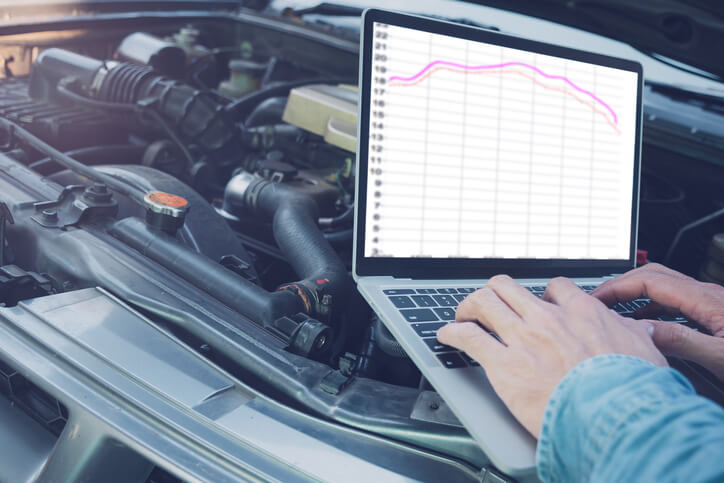 A student examining ignition timing and engine detonation data