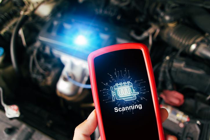 A student diagnosing a camshaft position sensor problem with a scan tool
